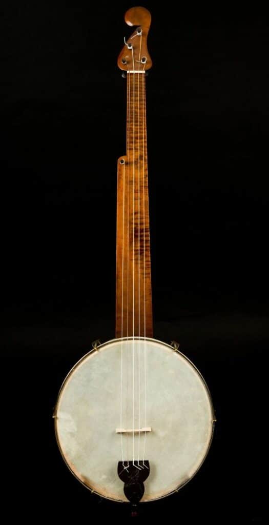 Is Banjo Hard To Learn? My Honest Opinion For Beginners A 5-String Banjo On A Black Background