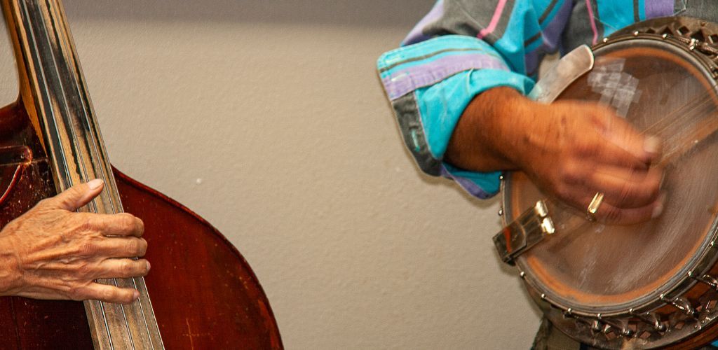 Is Banjo Hard To Learn? My Honest Opinion For Beginners A Banjo Player Playing A Fast Tempo Song With A Double Bass