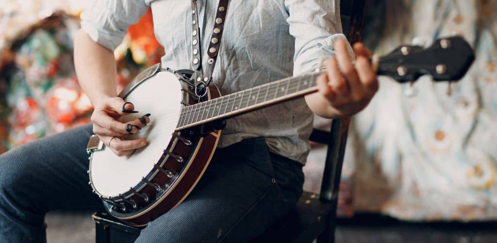 Is Banjo Hard To Learn? My Honest Opinion For Beginners A Banjo Player Using A Finger Pick While Playing The Banjo
