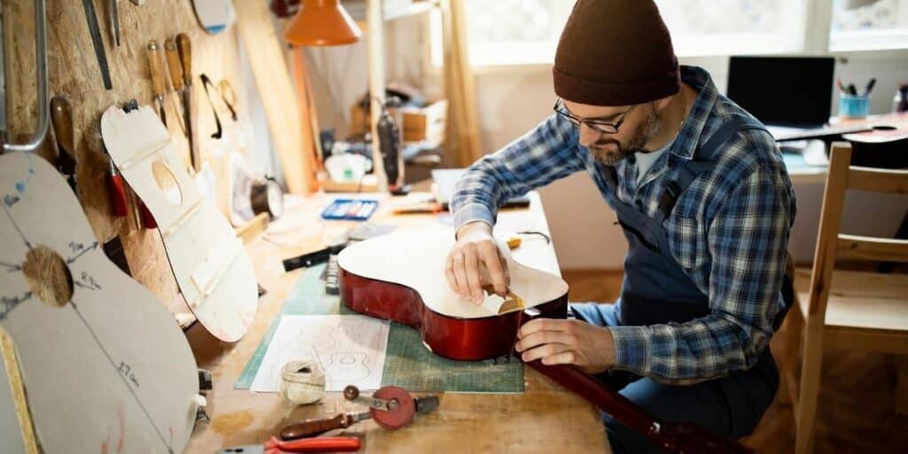 Are Yamaha Guitars Good? Discover The Perfect Sound For Every Musician A Guitar Maker Precisely Double Checking The Guitar He Is Making
