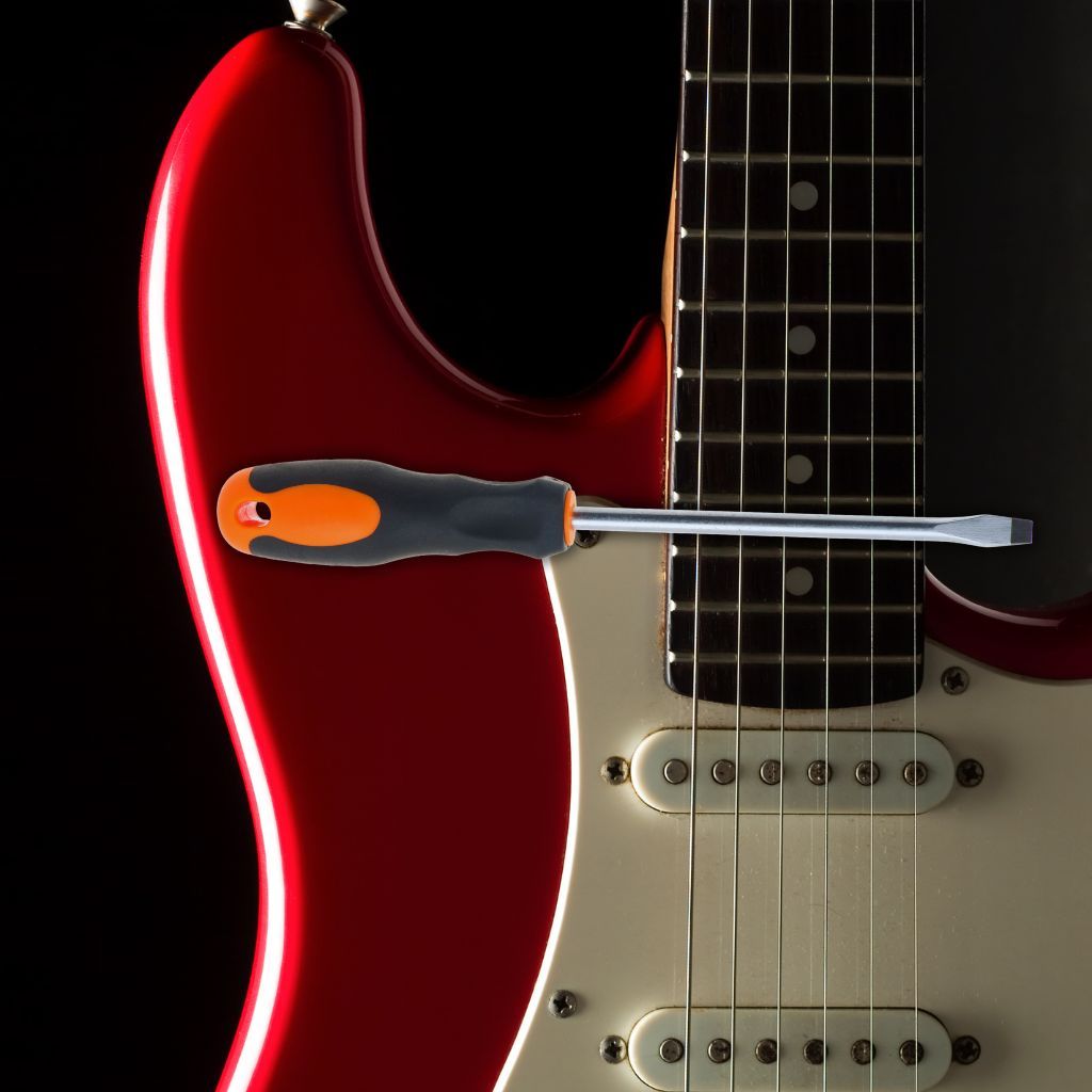 10 Crazy Things Guitarists Have Used To Play Solos—You Won'T Believe What’s On This List! A Red Electric Guitar With A Screwdriver