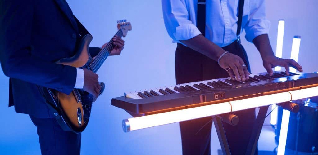 Yamaha Psr 8000: Unleash Your Musical Potential Today An Electric Guitarist Jamming With A Keyboardist