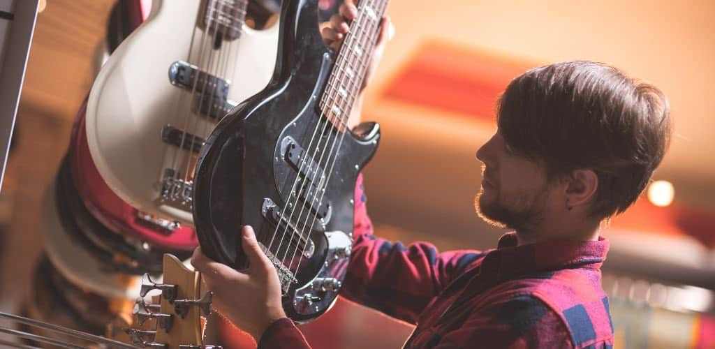 Ibanez Ergodyne Bass Guitar A Person Choosing What Bass Guitar To Buy
