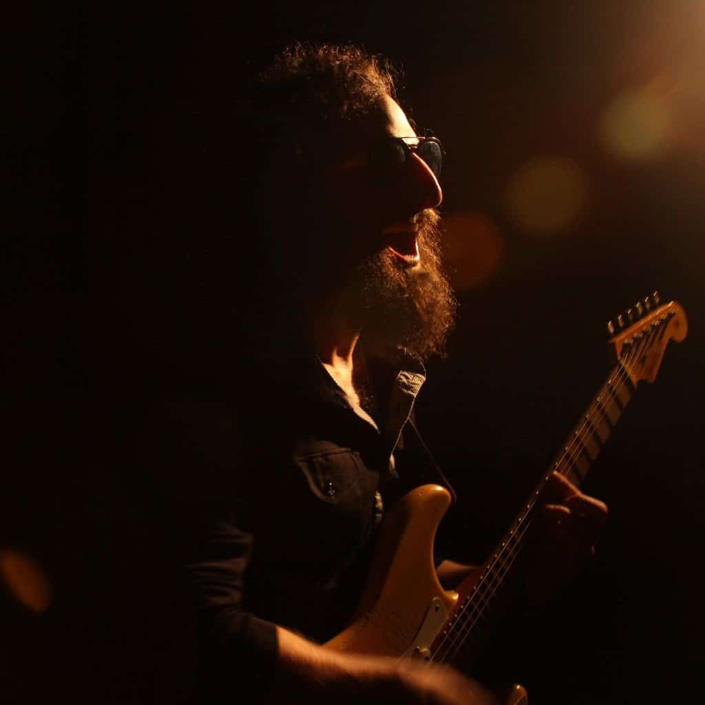 Stratocaster Review: Unveiling The Iconic Guitar'S Timeless Appeal An Electric Guitarist Wearing Sunglasses While Playing The Guitar