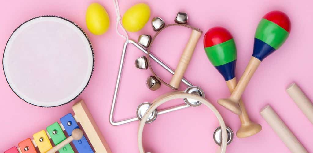 Smallest Instrument In The World A Group Of Small Instruments On A Pink Background