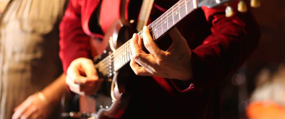 A Guitar Player'S Hands Playing Jazz On A Guitar