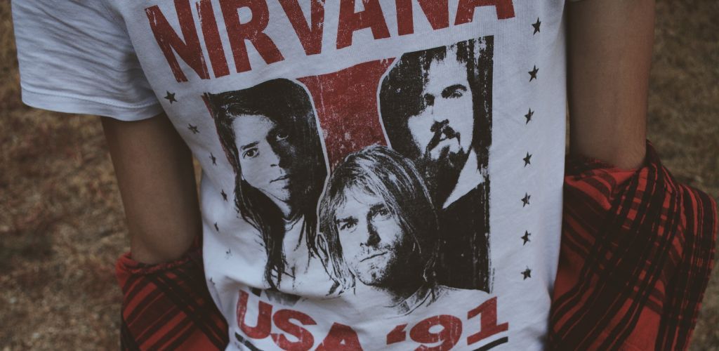 From The Streets To The Stage: How The Electric Guitar Changed A Homeless Man'S Life A White Nirvana Shirt Showing The Members Of The Band