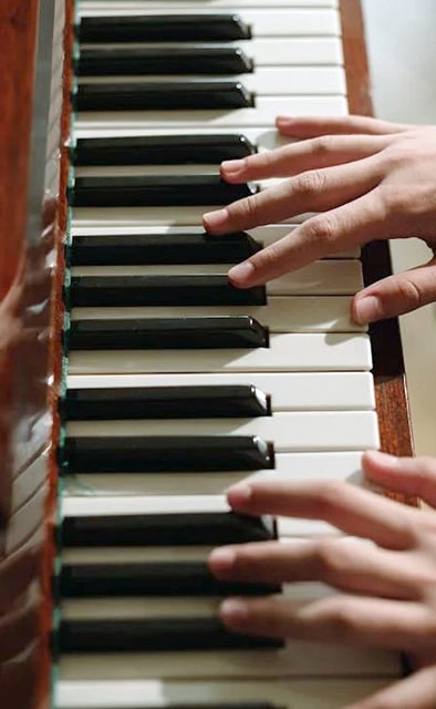 Hands Of Person On Piano Keys