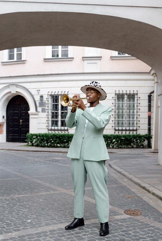 Can Playing The Trumpet Help You Live Longer? Scientists Think So! Man In Suit Playing Trumpet