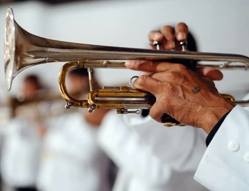 Can Playing The Trumpet Help You Live Longer? Scientists Think So! Person In White Dress Shirt Holding Trumpet