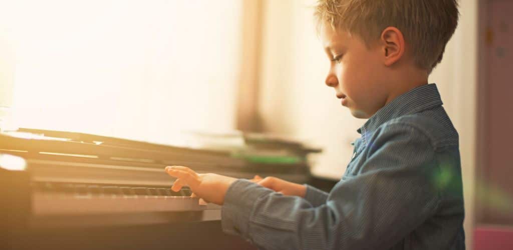 Yamaha Clavinova Clp 230: The Digital Piano That Inspires A Boy Playing The Digital Piano By The Window