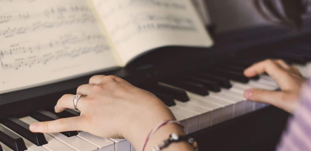 Yamaha P-155: Unleashing Your Musical Potential With Ease A Pianist Hands Playing A Digital Piano By Following A Music Sheet