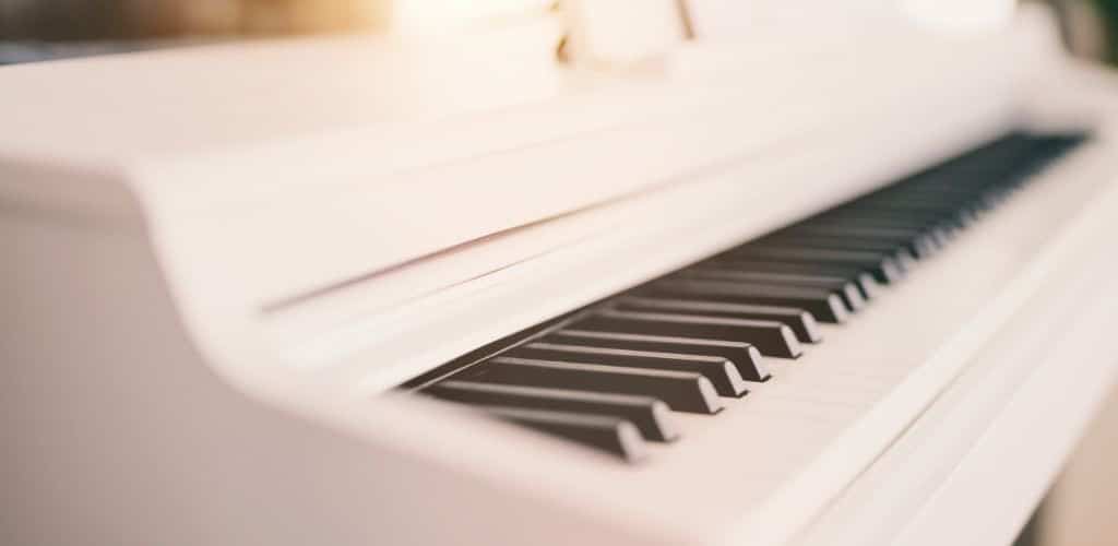 A White Digital Piano Showing The White And Black Ivory Keys