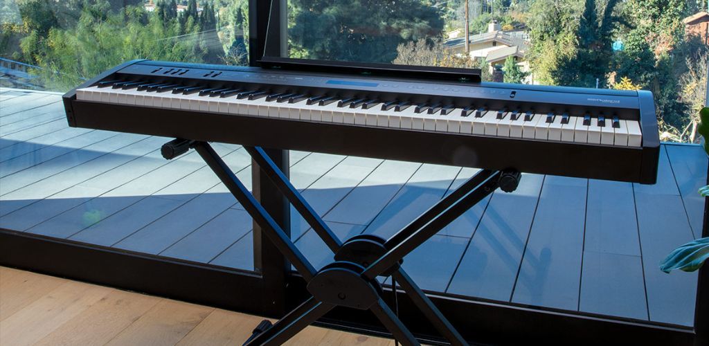 Roland Fp60X: Unlock Your Ultimate Piano Performance A Roland Product Image Of A Roland Fp60X By A Glass Window