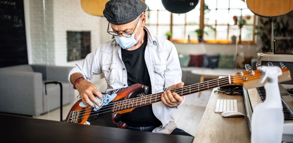 Ibanez Ergodyne Bass Guitar A Bass Guitarist Wiping Down His Bass Guitar After Playing