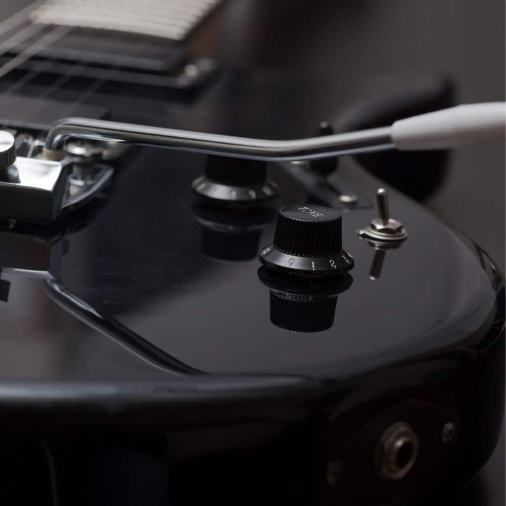 Stratocaster Review: Unveiling The Iconic Guitar'S Timeless Appeal A Photo Focused On A Whammy Bar Of A Black Electric Guitar