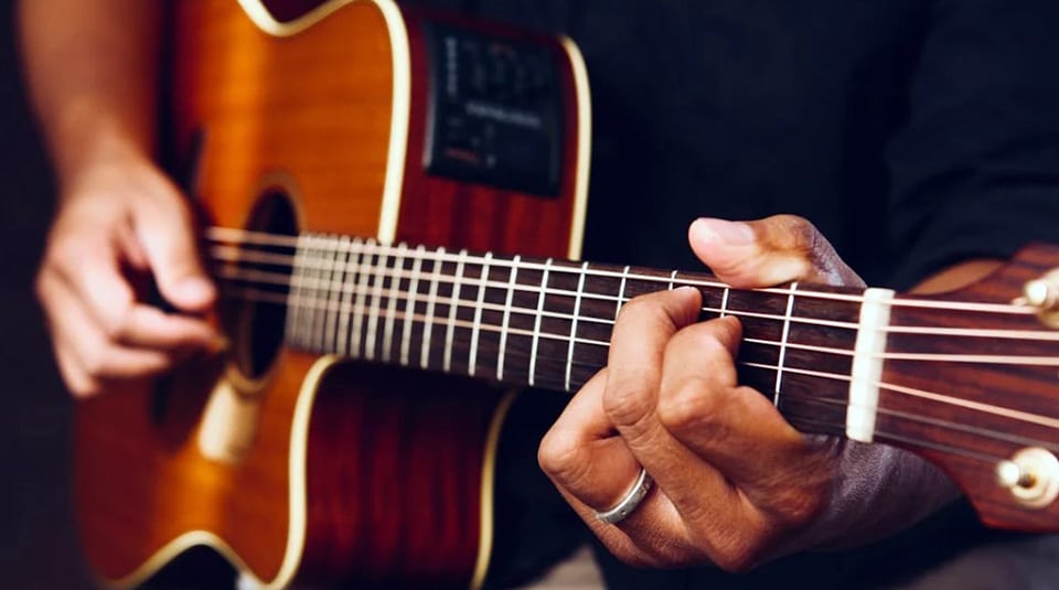Person Playing Acoustic Guitar