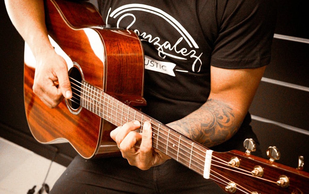 Person Playing An Acoustic Guitar
