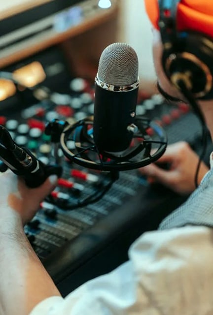 Best Audio Interface For Rode Podmic: Top Picks For Perfect Sound Quality Person In Front Of A Microphone