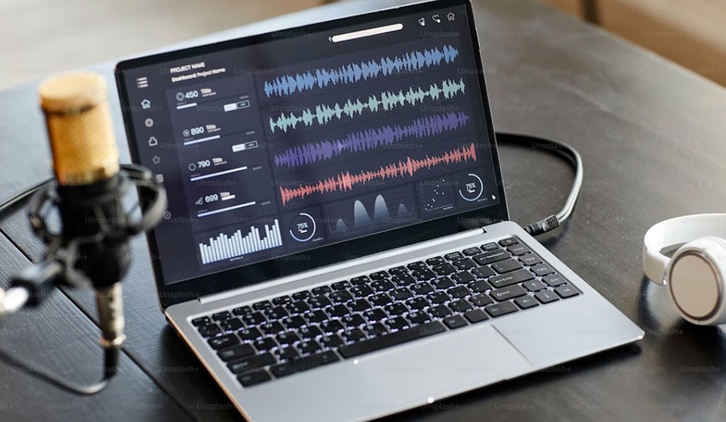 Recording Studio Setup With Microphone And Audio Tracks On Laptop Screen