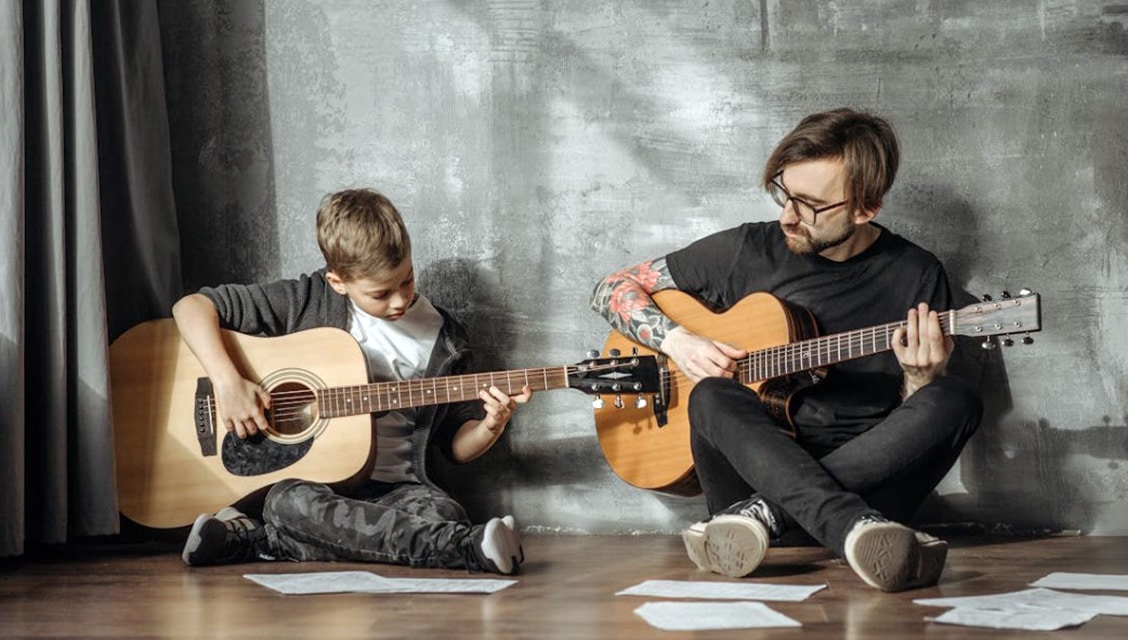 Easy To Learn Instruments For Adults: Start Your Musical Journey Today Man And Child Playing Guitars