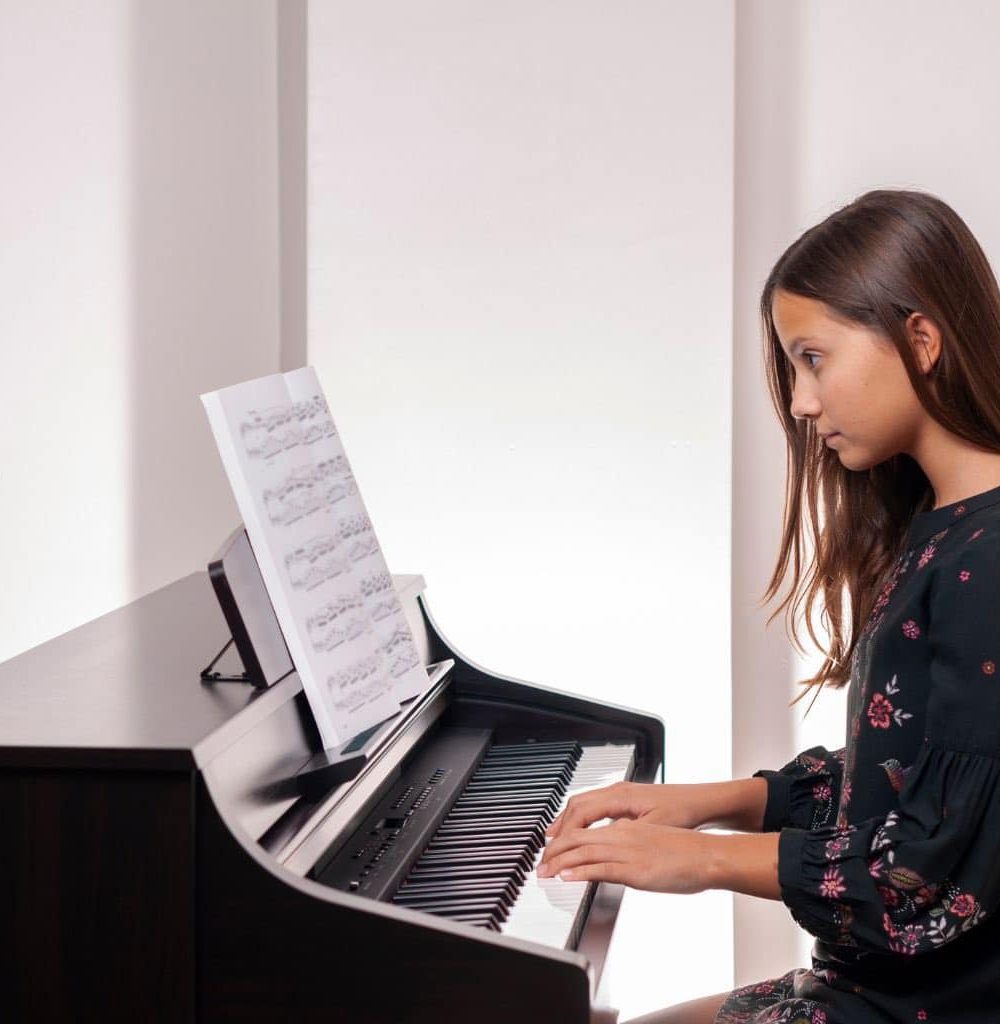 A Child Playing The Digital Piano While Using The Music Rest A Child Playing The Digital Piano While Using The Music Rest