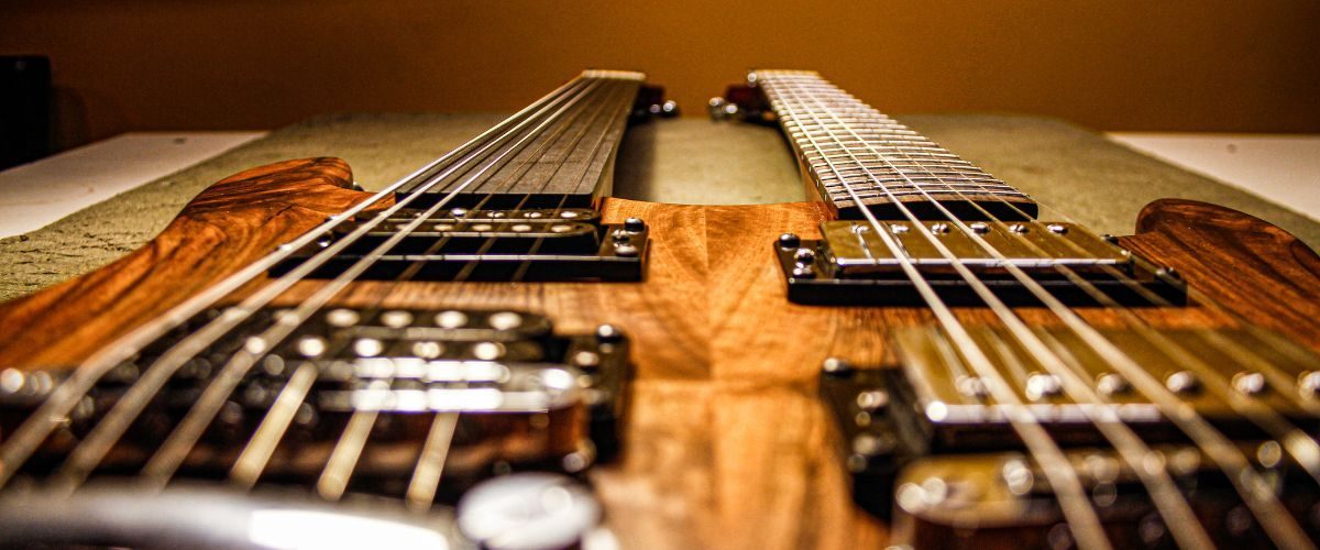 A Double Neck Electric Guitar Resting On A Table A Double Neck Electric Guitar Resting On A Table