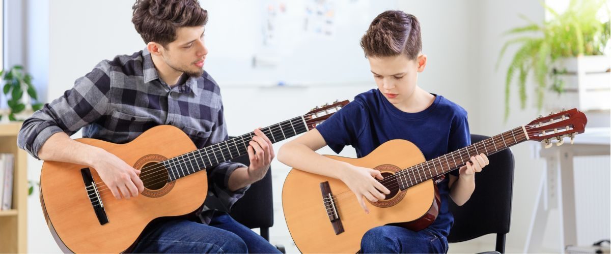 A Guitar Teacher Mentoring His Guitar Student