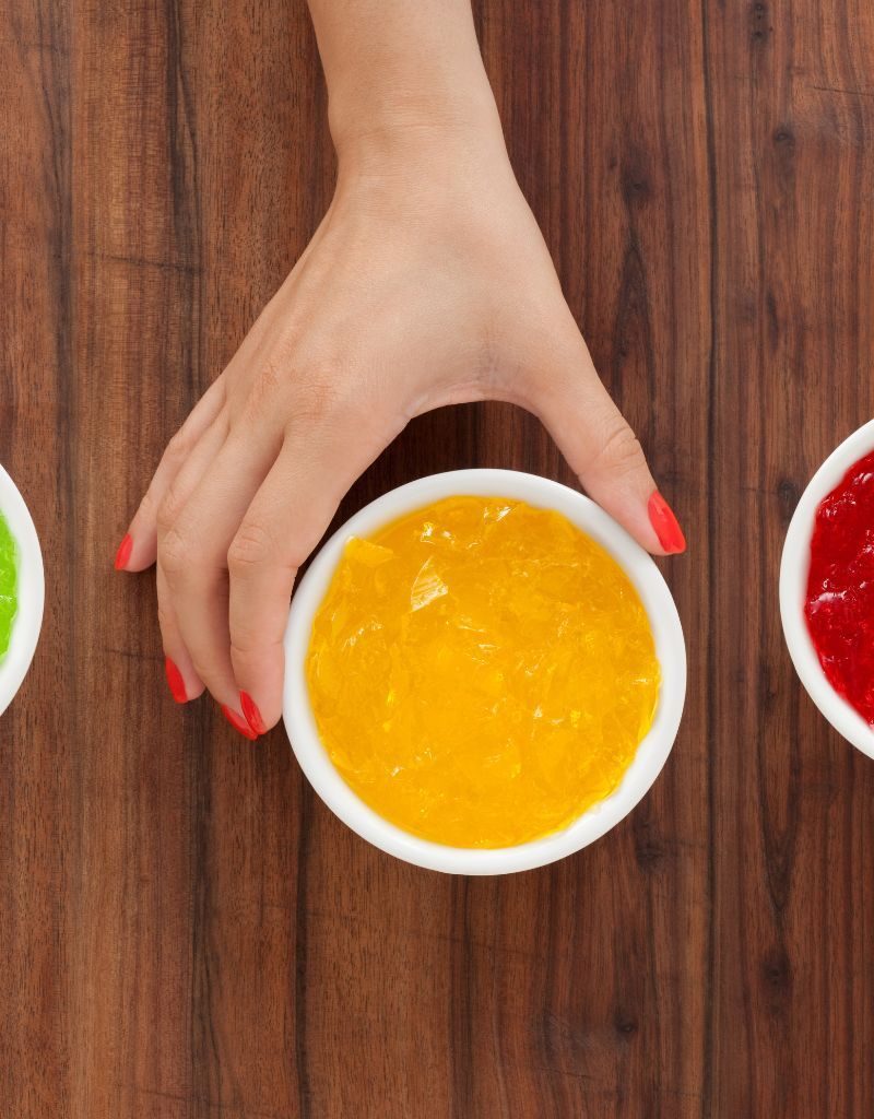 A Hand Holding A Yellow Jello A Hand Holding A Yellow Jello