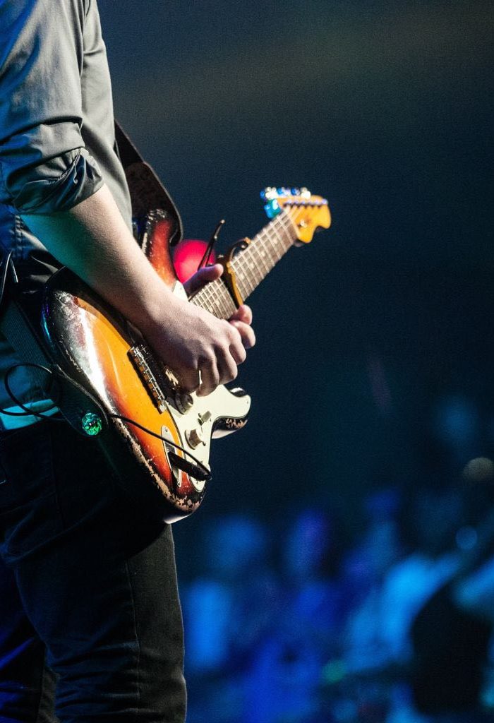 A Photo Focused On The Hands Of An Electric Guitarist Performing A Solo A Photo Focused On The Hands Of An Electric Guitarist Performing A Solo