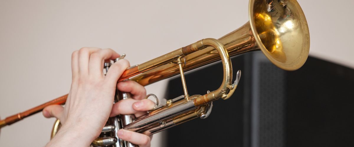 A Trumpet Player’S Hands Playing A Gold Trumpet A Trumpet Player'S Hands Playing A Gold Trumpet