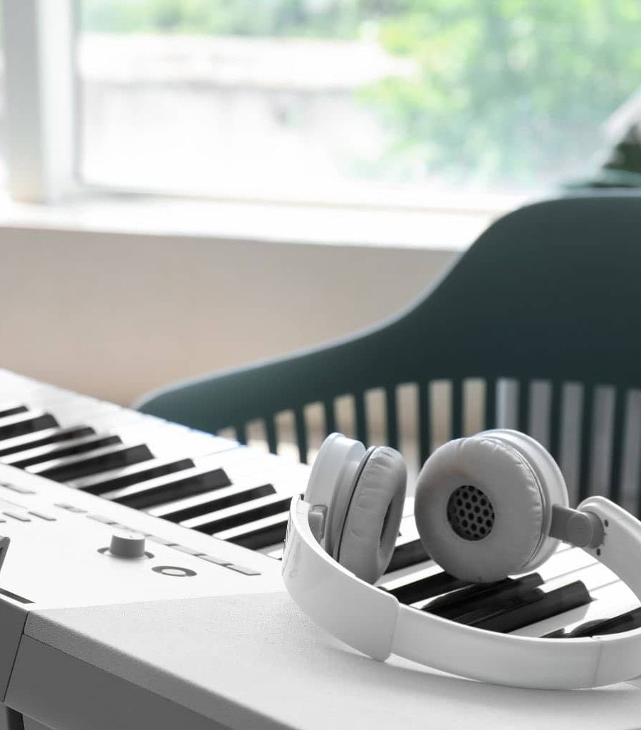 A White Headphones On Top Of A Portable Digital Piano